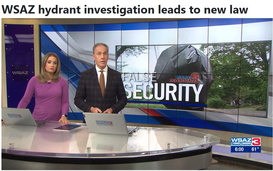 Two reporters at a news desk in front of a TV screen that says False Security